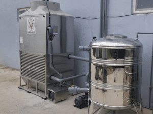 a large stainless steel tank next to a wall