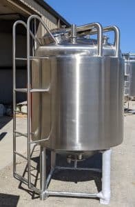 a large metal tank sitting outside of a building