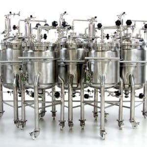 a group of stainless steel tanks sitting next to each other