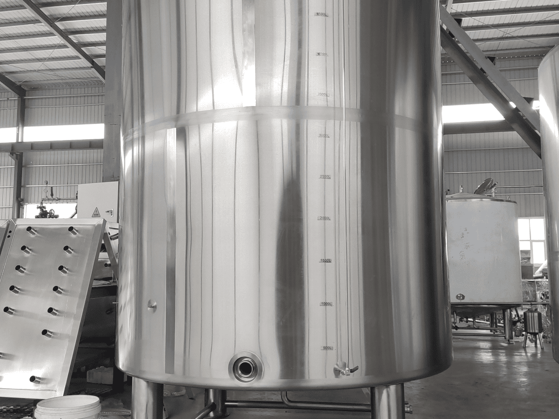 a large silver tank in a factory.