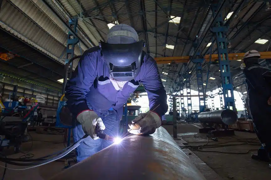 Welder performing argon welding on carbon steel