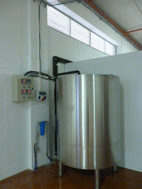 a large stainless steel tank sitting in a room.