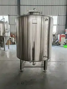 A large stainless steel tank in a warehouse
