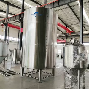 a large stainless steel tank in a warehouse