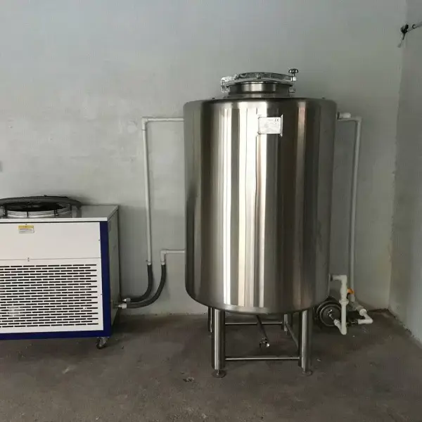 a large stainless steel tanks next to a heater