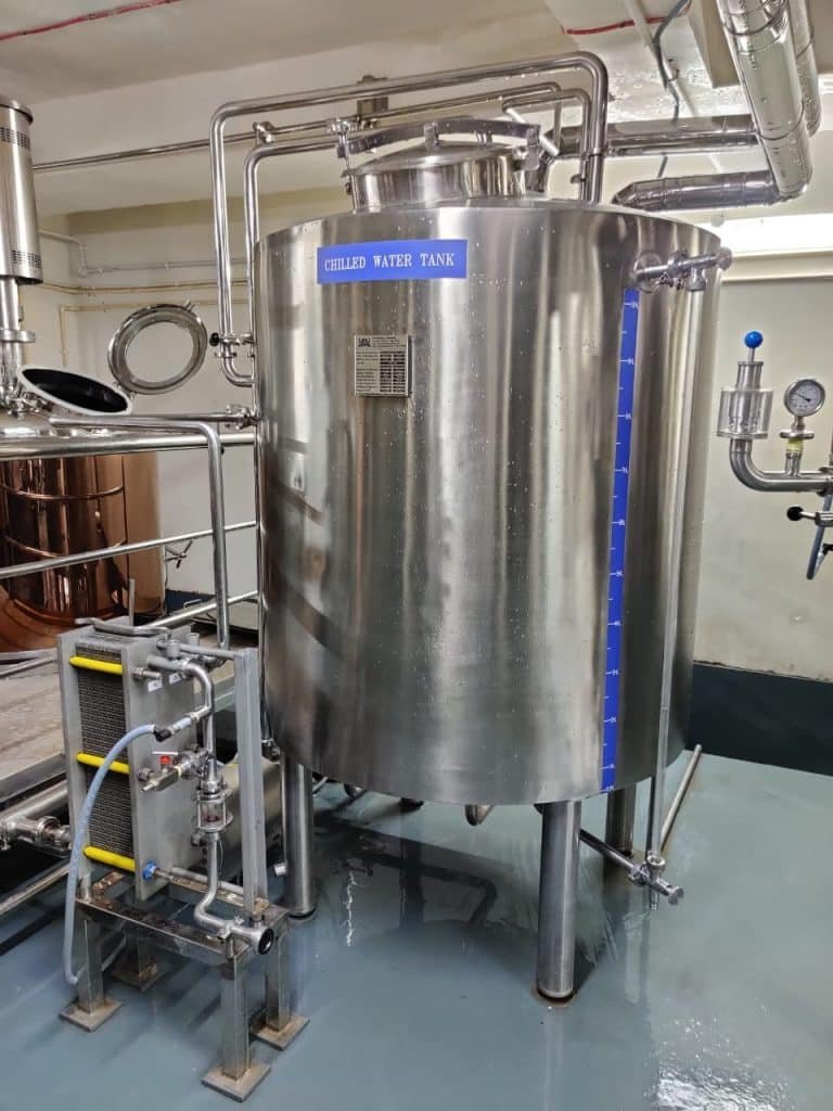 a large stainless steel tank sitting inside of a building