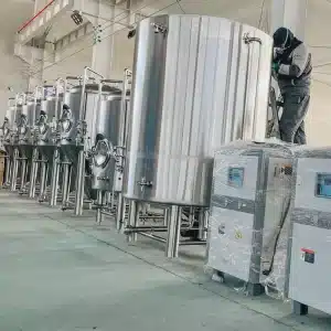 a man standing next to a machine in a factory