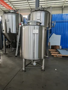 two large stainless steel tanks in a warehouse