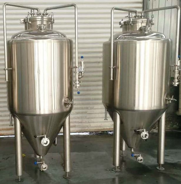 Two stainless steel tanks sitting next to each other