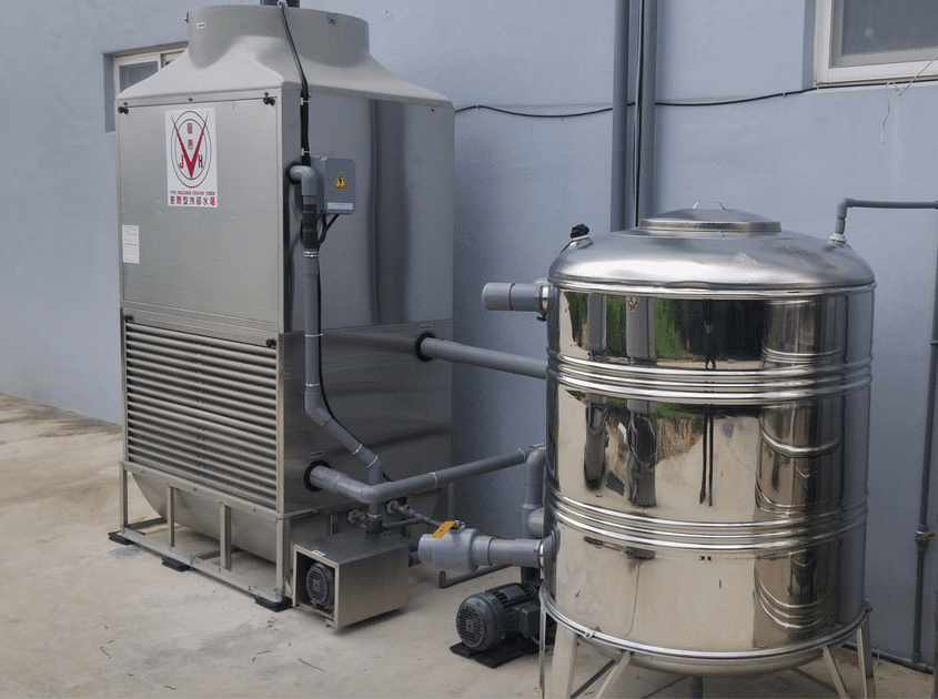 a large stainless steel tank next to a wall