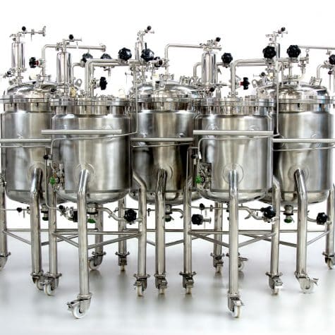 a group of stainless steel tanks sitting next to each other