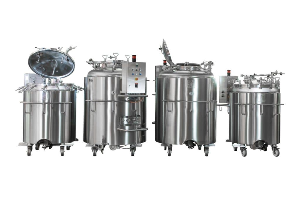 a group of stainless steel tanks sitting next to each other