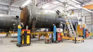 a large metal tank being worked on in a factory