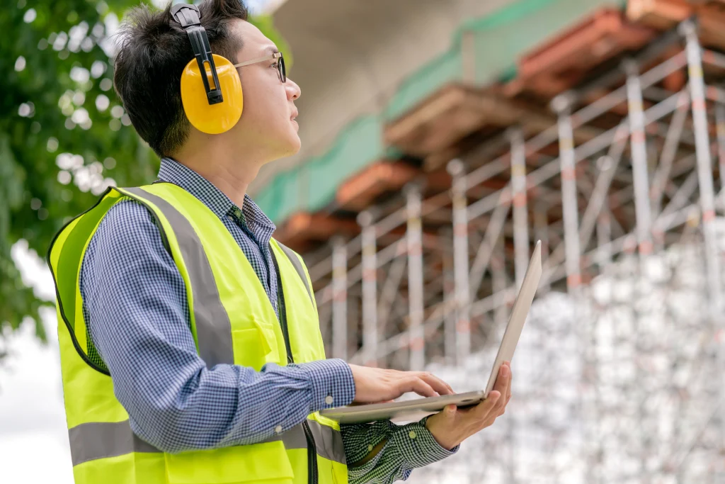 Technician testing industrial pressure vessel noise levels