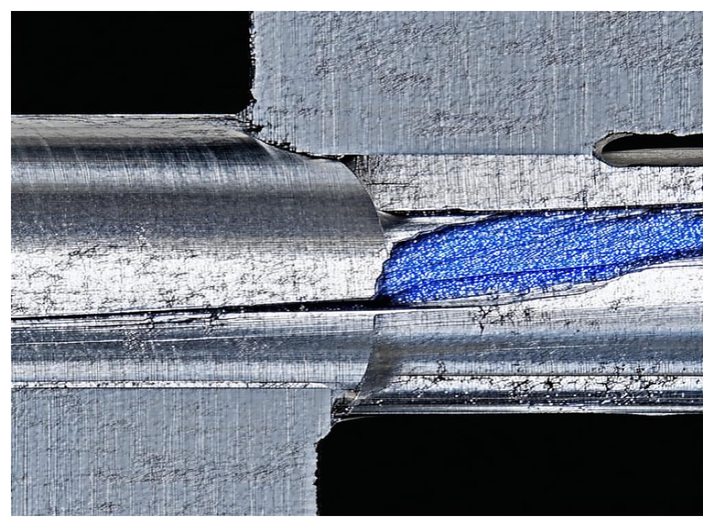 Cross-section of dissimilar metal weld joint in pressure vessel showing transition zone between stainless steel and carbon steel
