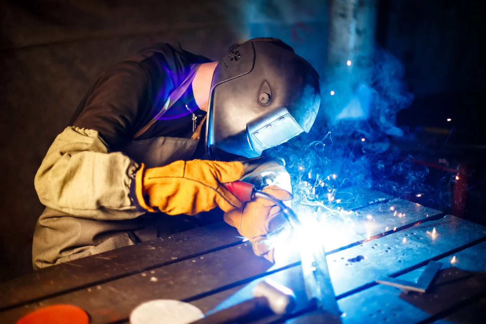 Welder showing what does 3g welding position mean with vertical weld