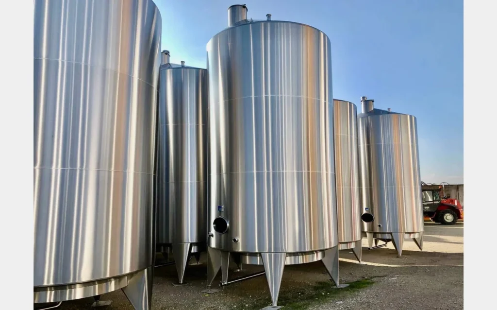 A group of a large metal tanks sitting next each other.