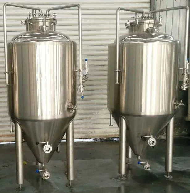 Two stainless steel tanks sitting next to each other.
