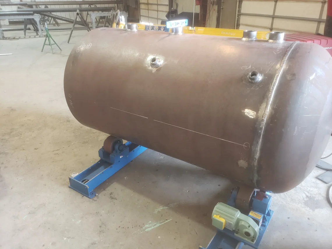 Technicians performing final quality checks on a pressure vessel