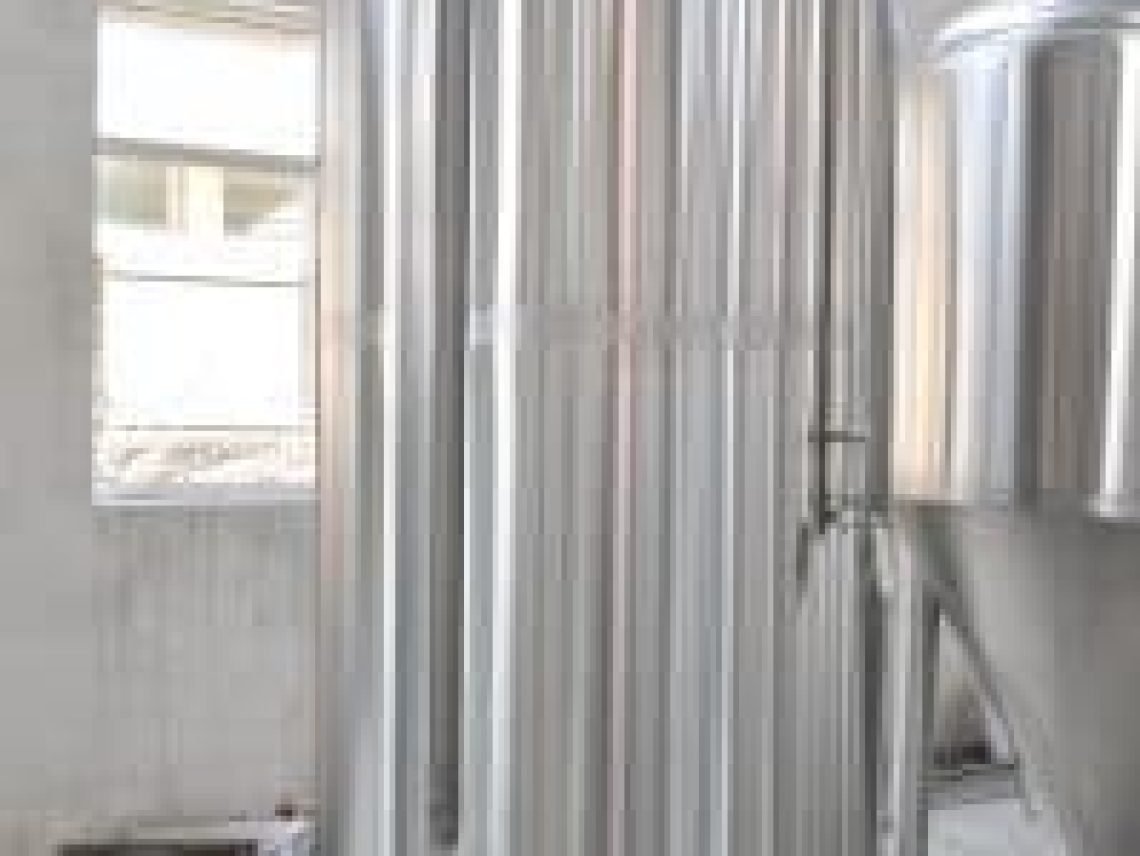 A large metal tank sitting inside of a building
