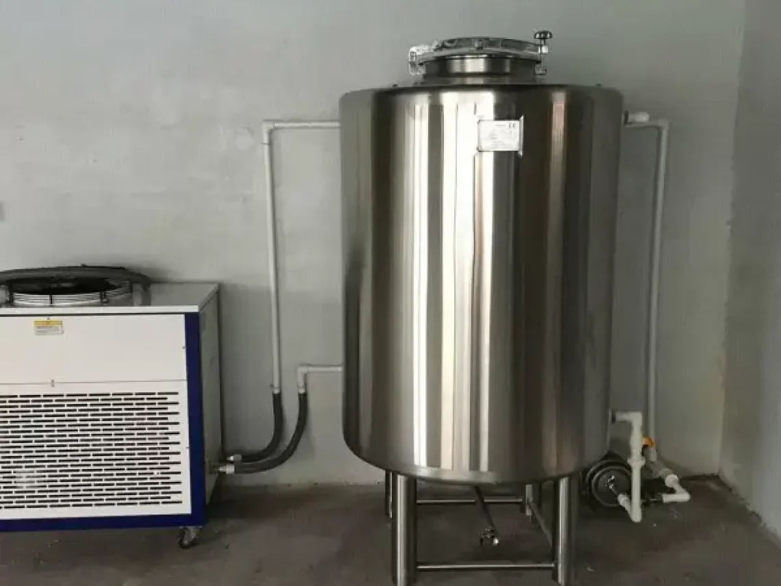 a large stainless steel tanks next to a heater