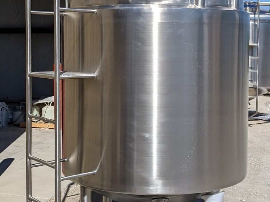 a large metal tank sitting outside of a building.