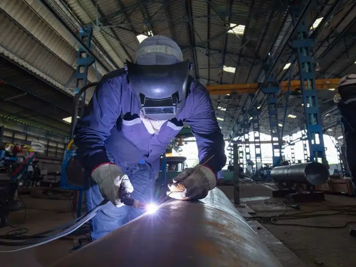 Welder performing argon welding on carbon steel